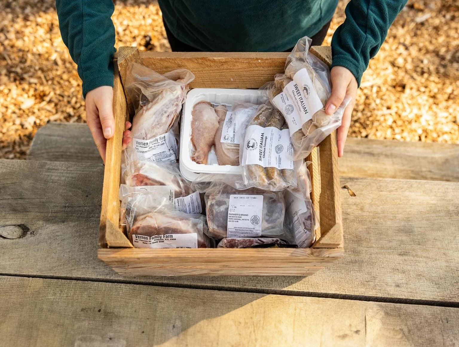 Wood crate of local farm meat for a Rhode Island meat box guide.