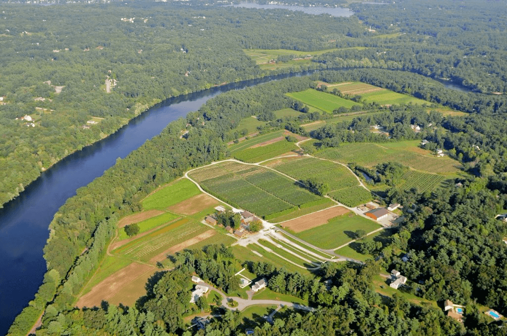 Aerial view of farm fields, buildings, and river shoreline at Parlee Farms, Tyngsborough, Massachusetts.